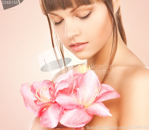 Image of lovely woman with red lily flower