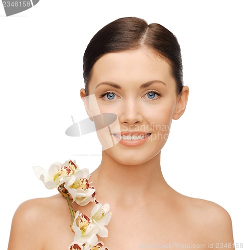 Image of lovely woman with orchid flower