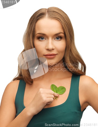 Image of woman with spinach leaves