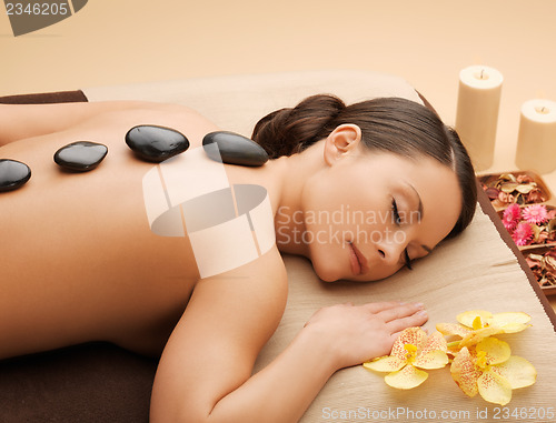 Image of beautiful woman with hot stones