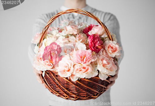 Image of man holding basket full of flowers