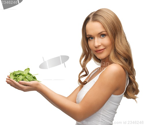 Image of woman with spinach leaves on palms