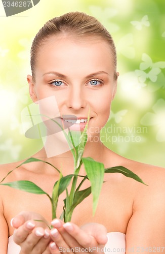 Image of woman with sprout and butterflies