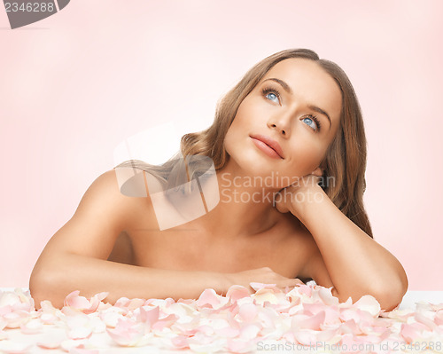 Image of beautiful woman with rose petals