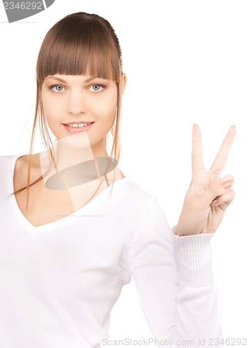 Image of young woman showing victory sign