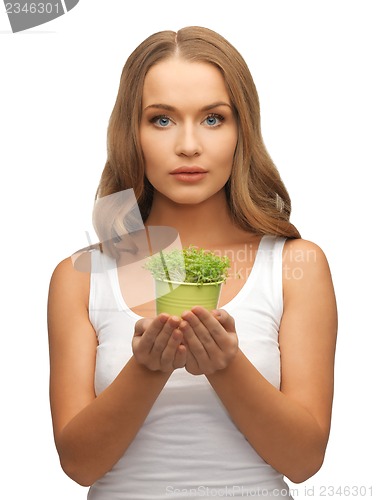 Image of woman with green grass in pot