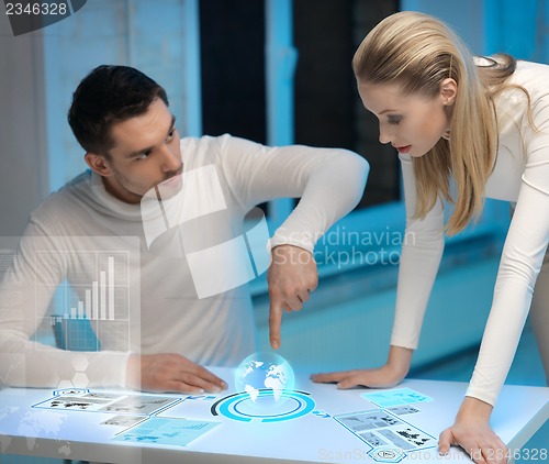 Image of man and woman working with virtual screens