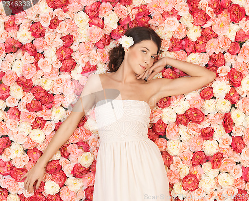 Image of young woman with background full of roses
