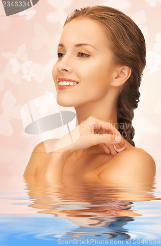 Image of beautiful woman with butterflies in water