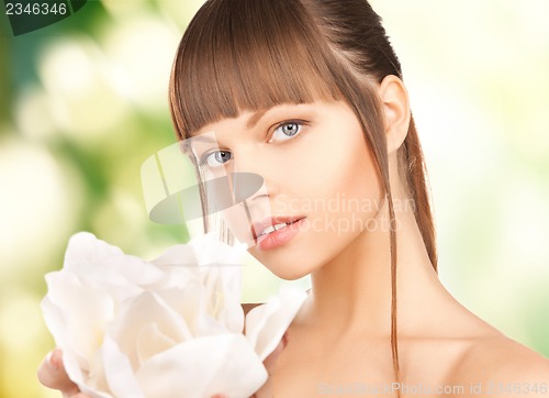 Image of beautiful woman with orchid flower
