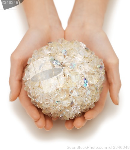 Image of woman hands holding bath ball