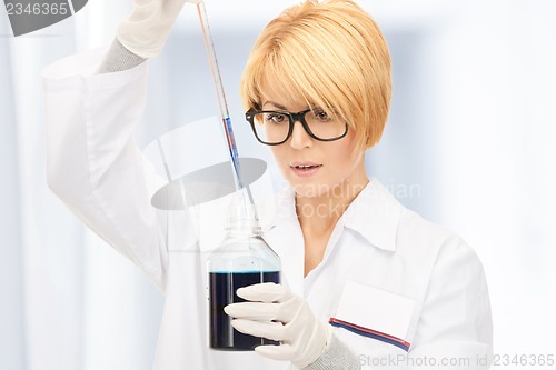 Image of lab worker holding up test tube