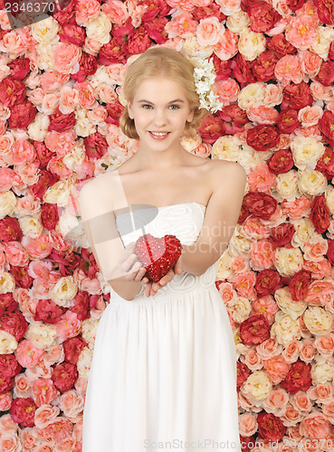 Image of woman with heart and background full of roses