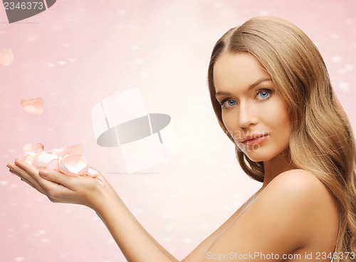Image of beautiful woman with rose petals