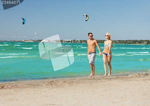 Image of couple walking on the beach