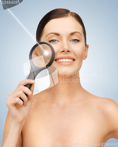 Image of woman with magnifying glass and laser