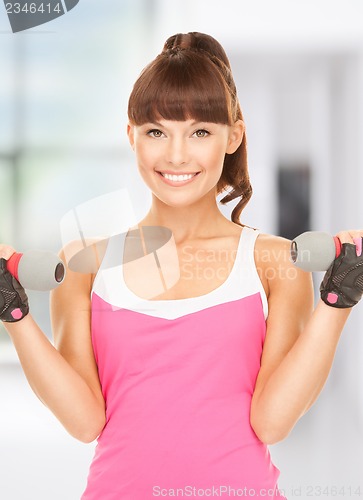 Image of fitness instructor with dumbbells