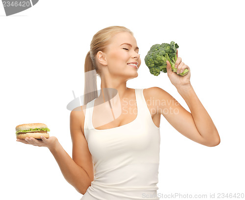 Image of woman with broccoli and hamburger