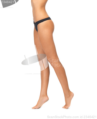 Image of female legs in black bikini panties