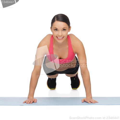 Image of beautiful sporty woman doing exercise