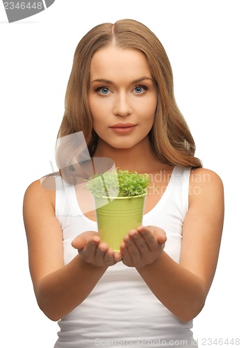 Image of woman with green grass in pot