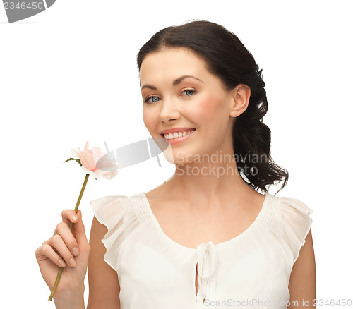 Image of young and beautiful woman with flower