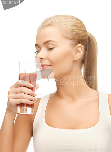 Image of young woman drinking tomato juice