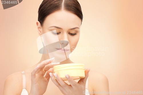 Image of beautiful woman with moisturizing creme