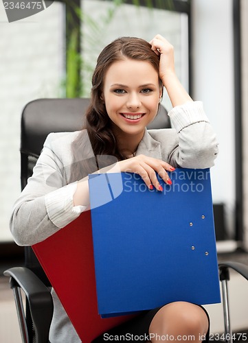 Image of beautiful smiling woman with folder
