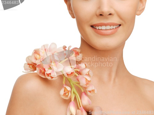 Image of lovely woman with orchid flower