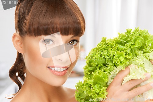 Image of woman holding lettuce