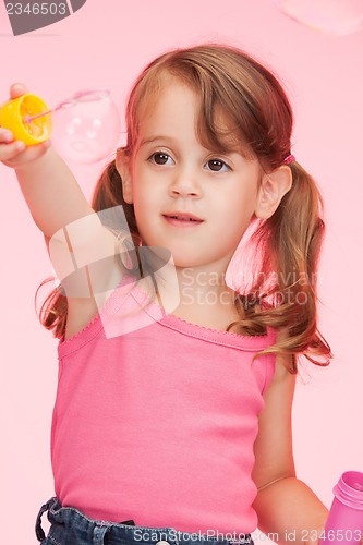 Image of litle girl with soap bubbles