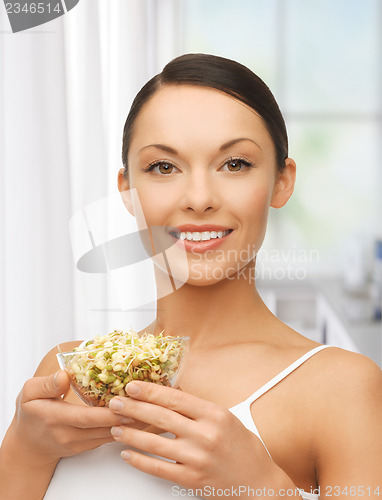 Image of healthy woman holding bowl with sprout