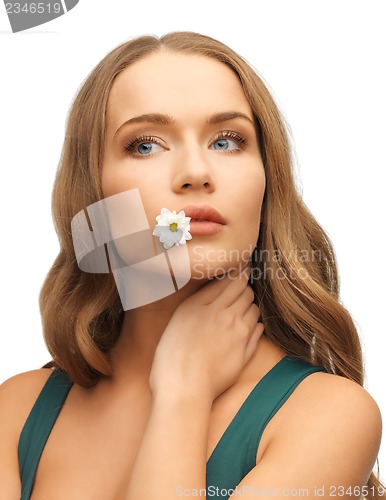 Image of woman with camomile in mouth