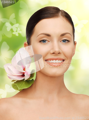 Image of lovely woman with lily flower and butterflies