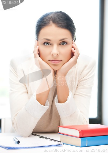 Image of bored and tired woman behid the table