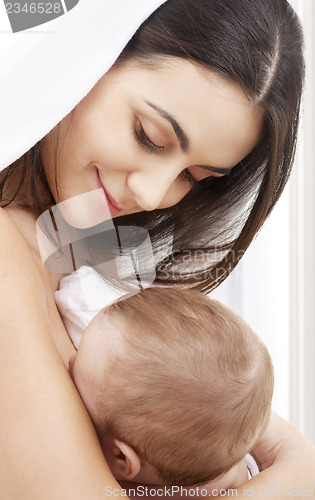 Image of happy mother with baby at home