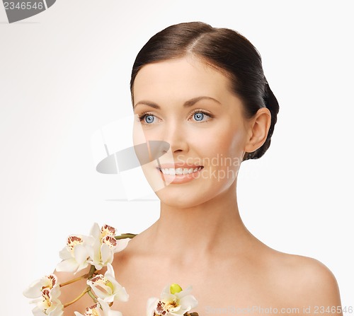 Image of lovely woman with orchid flower