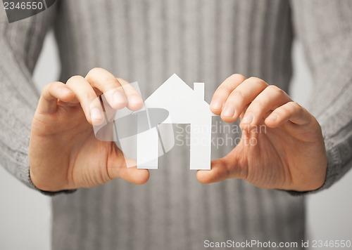 Image of man holding paper house