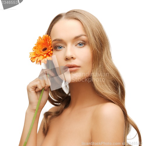 Image of lovely woman with gerbera flower