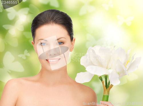 Image of lovely woman with lily flower and butterflies