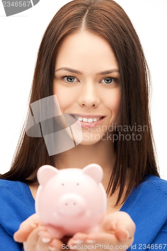 Image of lovely woman with small piggy bank