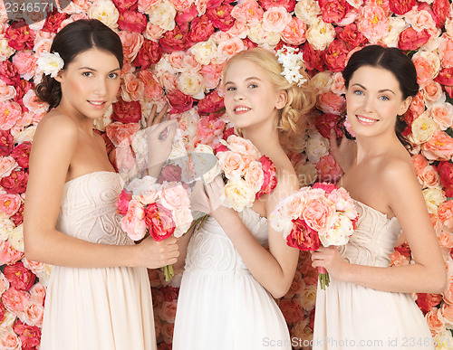 Image of three women with background full of roses