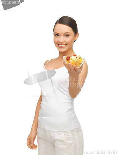 Image of healthy woman holding bowl with fruit salad