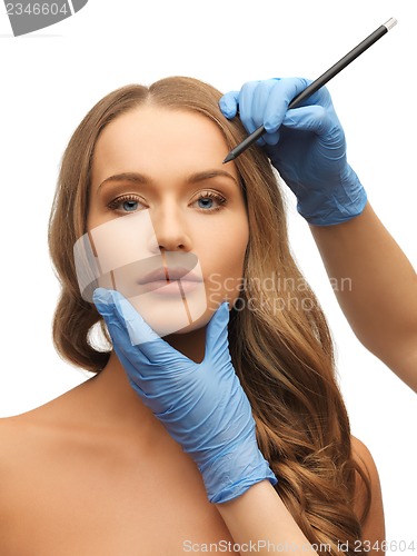 Image of woman face and beautician hands