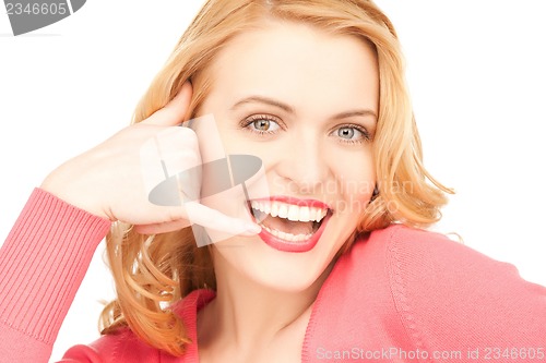 Image of woman making a call me gesture