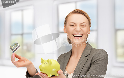 Image of lovely woman with piggy bank and money