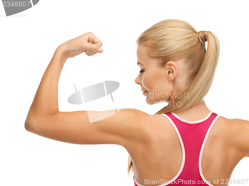 Image of sporty woman showing her biceps