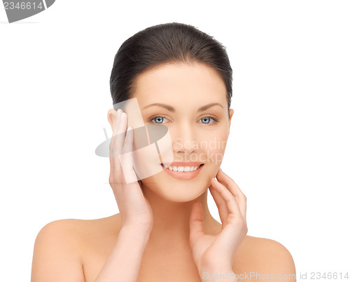 Image of woman touching her face