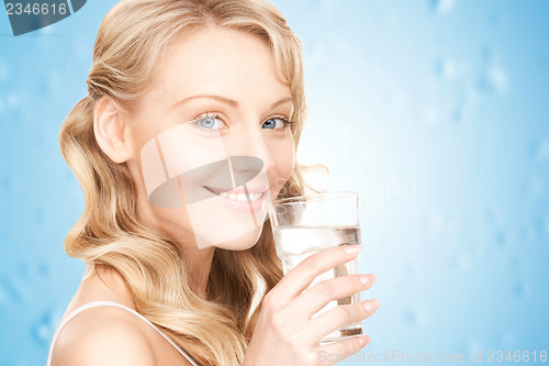 Image of woman hands holding glass of water